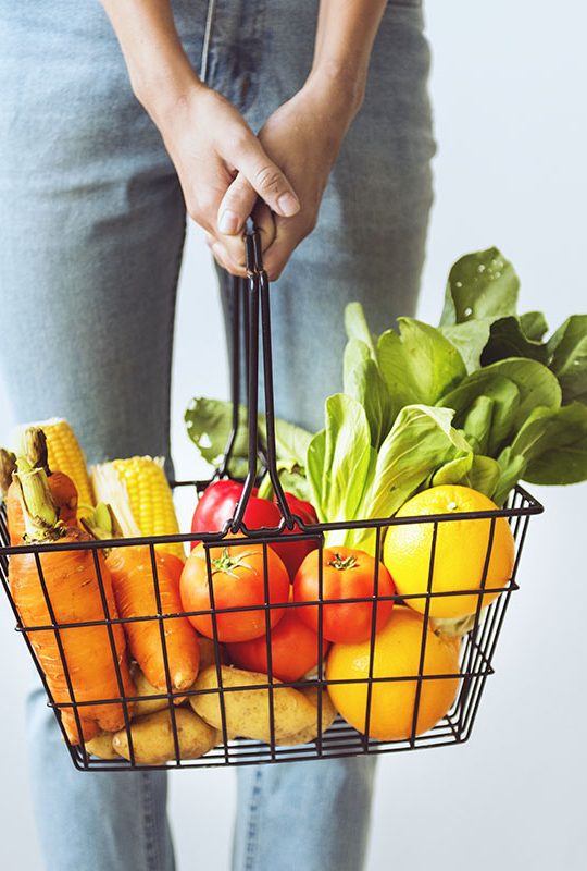 Woman holding vegetable basket Woman holding vegetable basket